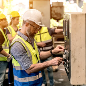 Industrial factory concept. Engineering with technician and worker operating and maintenance of machinery.